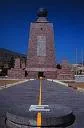 Equatorial monument with a yellow line across the plaza