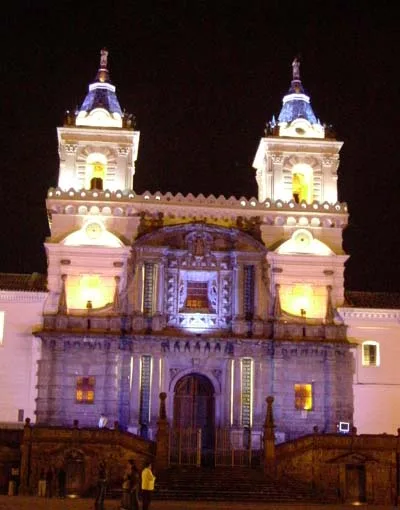 Twin-towered church illuminated against the night sky